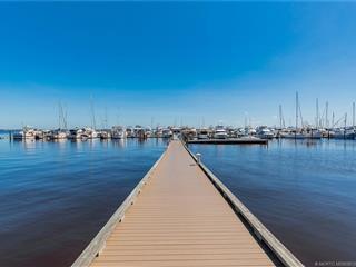 A wooden pier extends into a marina filled with numerous sailboats and yachts — 815 NW Flagler Avenue # 302, Stuart FL 34994, STUART, FL