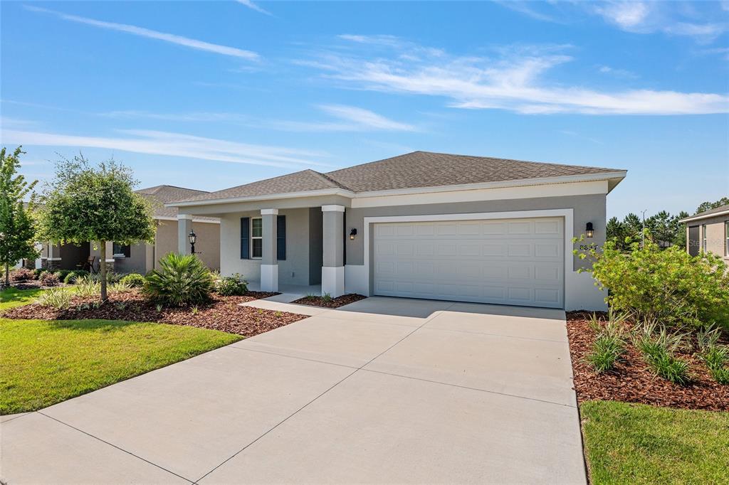 A single-story house with a two-car garage, gray exterior, and a concrete driveway — 8837 SW 79TH LOOP, OCALA, FL