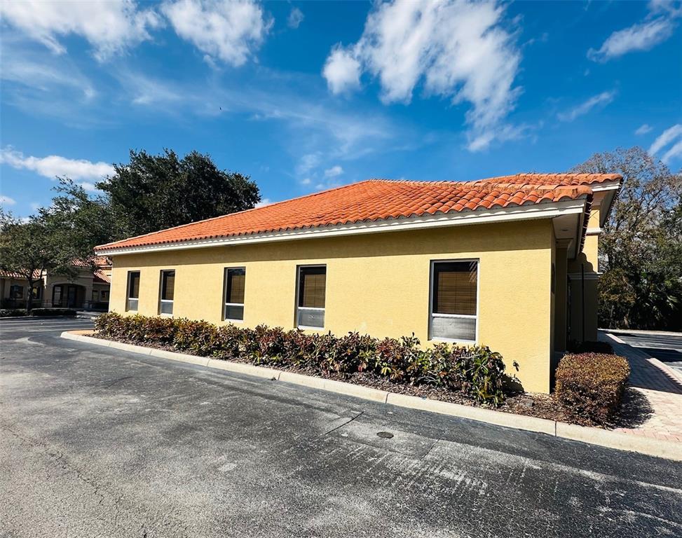 A yellow commercial building with a terracotta tile roof and a parking lot — 5115 S LAKELAND DRIVE, LAKELAND, FL