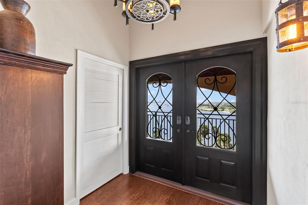 An entryway features a dark double door with glass inserts, a white door, and wood flooring — 761 MARINA POINT DRIVE UNIT 7610, DAYTONA BEACH, FL