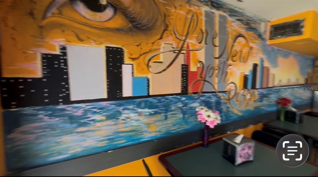A dining area features a large mural of the New York City skyline and an eye — 9852 E COLONIAL DRIVE, ORLANDO, FL