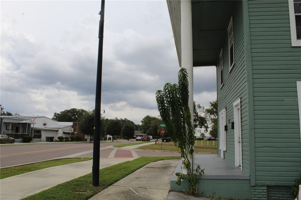 A view from the porch of a green house looking toward a street intersection — 1317 MAIN STREET, LEESBURG, FL