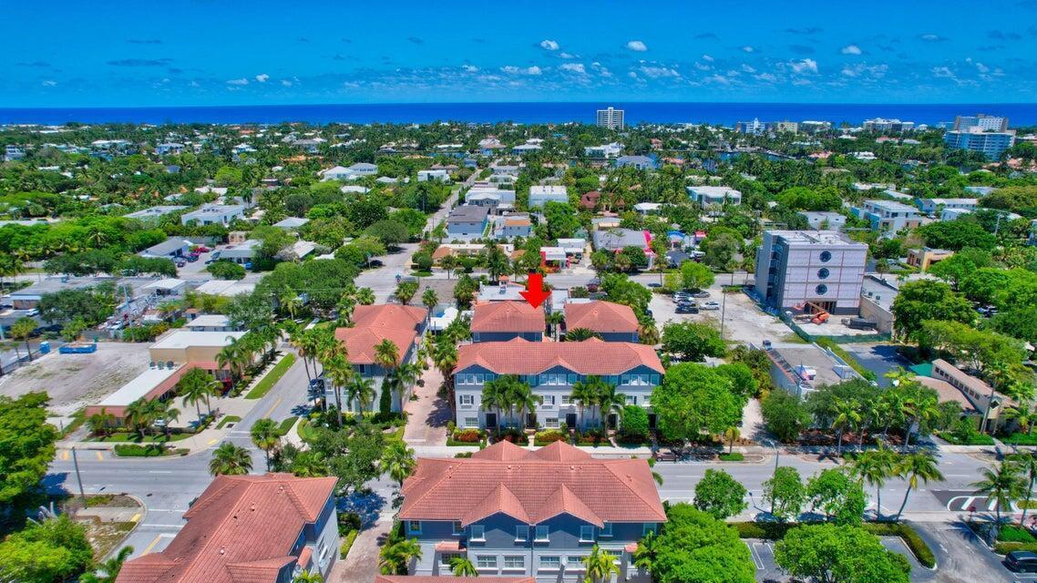An aerial view of a multi-story residential townhouse complex with red tile roofs — 295 NE 5th Avenue # 22, Delray Beach FL 33483, DELRAY BEACH, FL