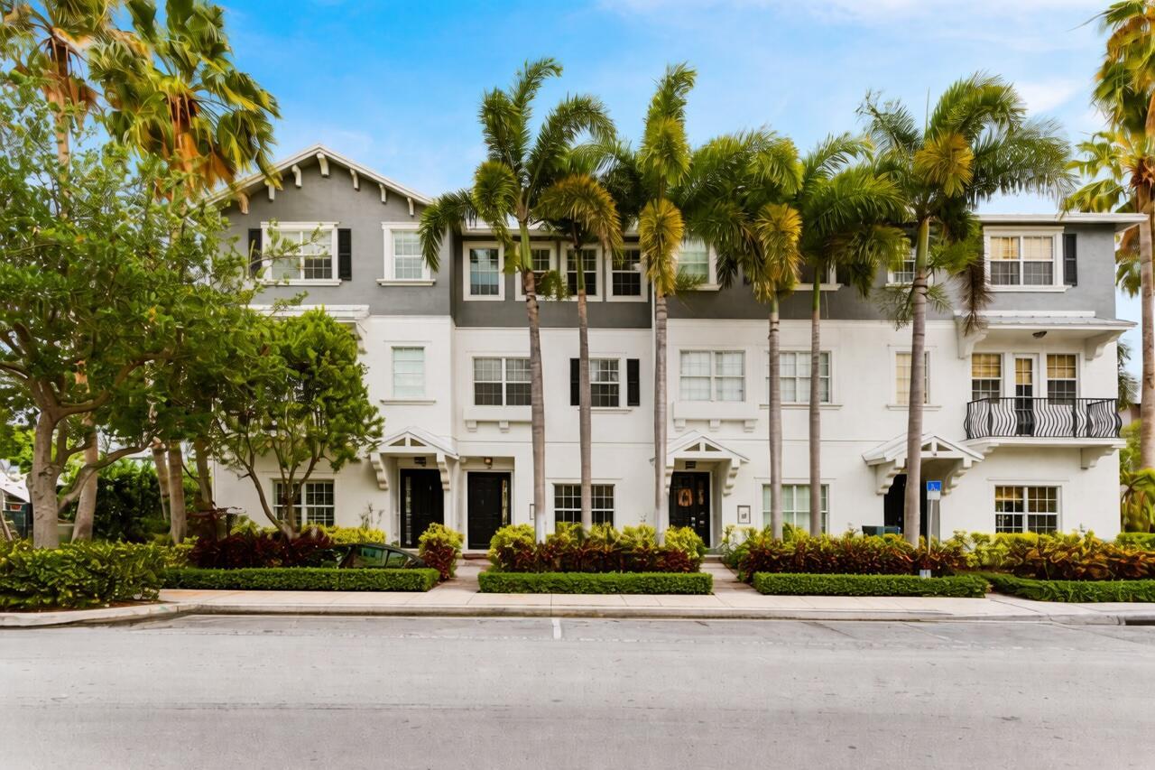 A multi-story townhouse complex with white and gray siding, palm trees, and a sidewalk — 295 NE 5th Avenue # 22, Delray Beach FL 33483, DELRAY BEACH, FL