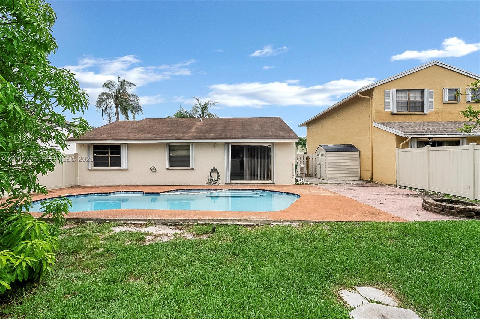 A backyard features a swimming pool, a patio, a storage shed, and a single-story house — 681 Thornridge Ave, Davie FL 33325, DAVIE, FL