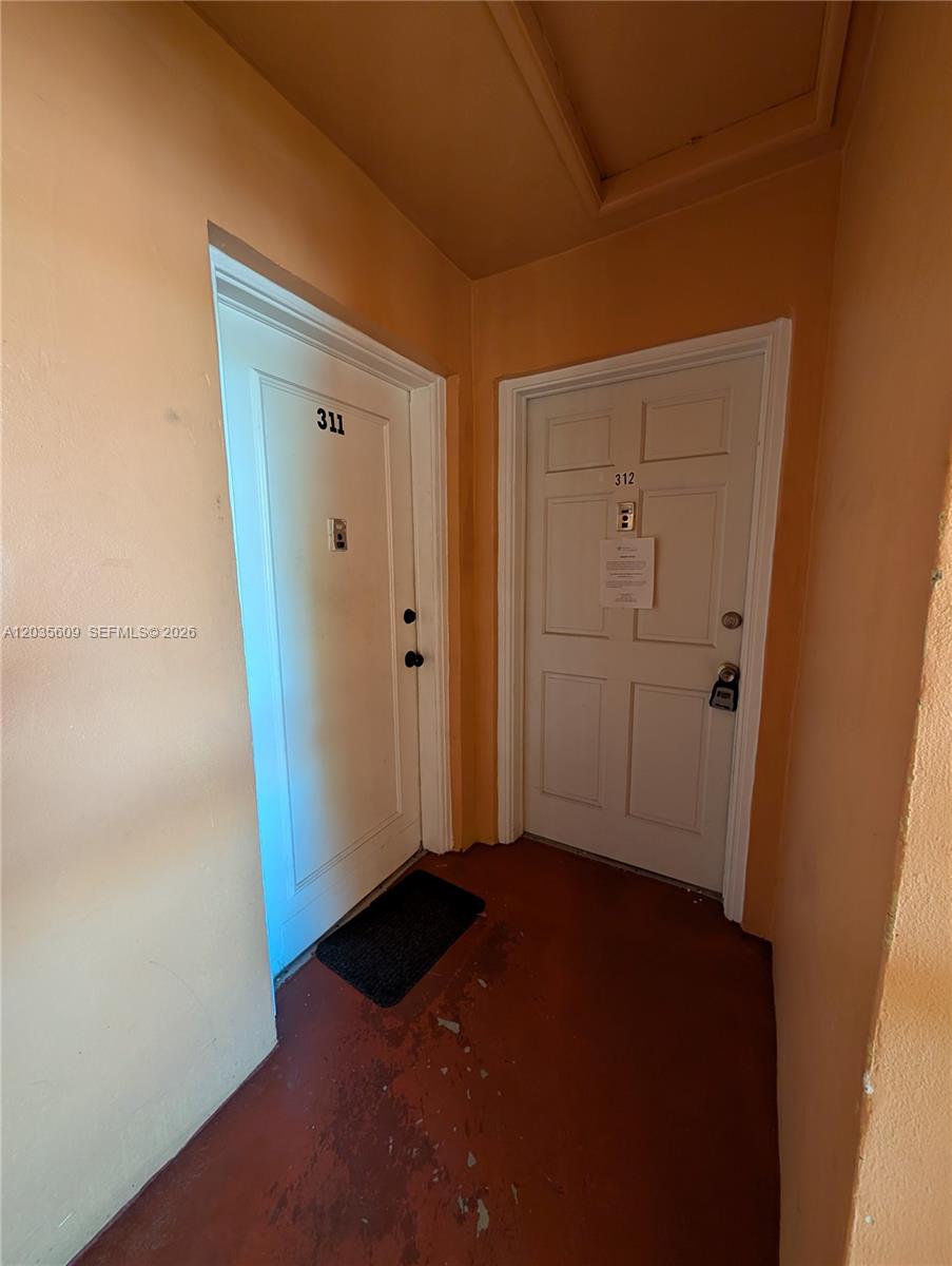 This photo shows a hallway with two white apartment doors labeled 311 and 312 — 19080 NE 3rd Ct # 311, Miami FL 33179, MIAMI, FL