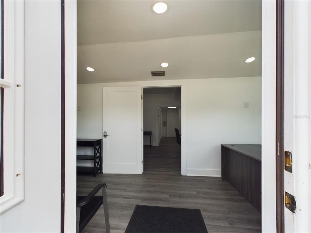 A view through a doorway into a room with gray wood-look flooring and white walls — 334 1ST STREET S, WINTER HAVEN, FL