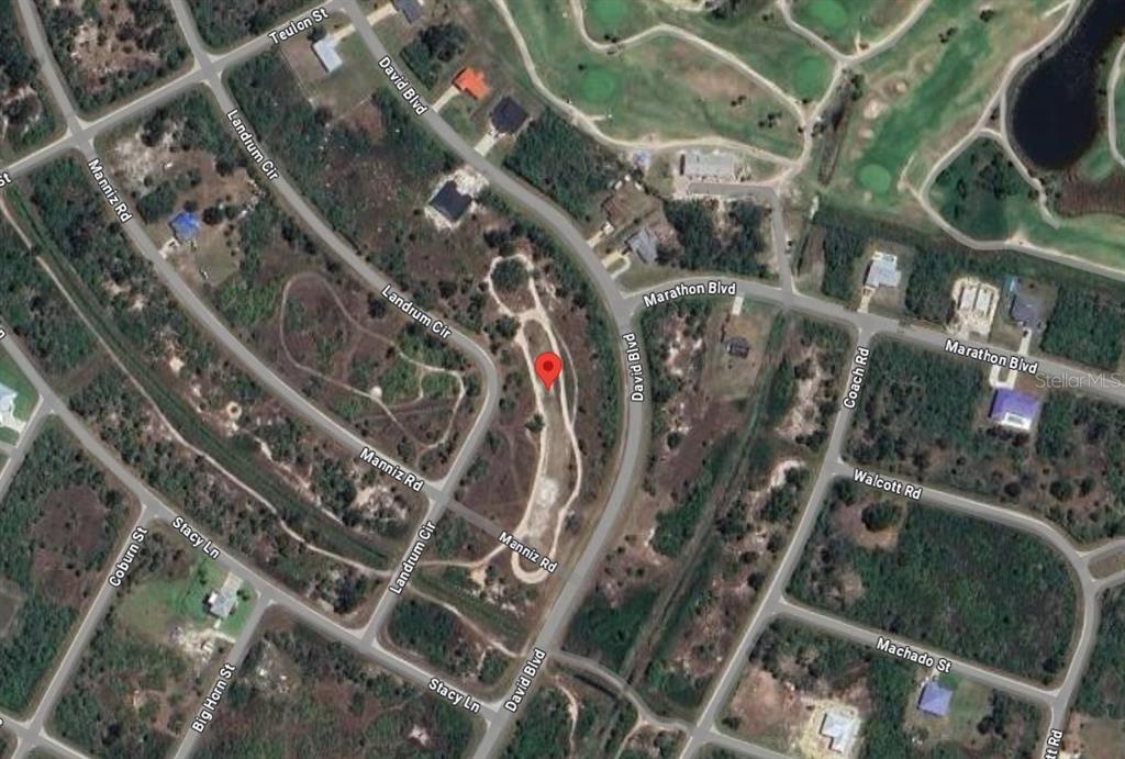 This is an aerial map view showing a vacant lot marked with a red pin — 7224 LANDRUM CIRCLE, PORT CHARLOTTE, FL