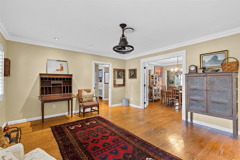 A living room features hardwood floors, a large area rug, a desk, and a cabinet — 553 ARAPAHO TRAIL, MAITLAND, FL
