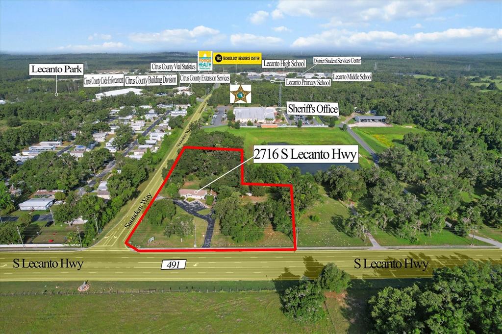 This aerial map shows a property outlined in red along a highway near several schools — 2716 S LECANTO HIGHWAY, LECANTO, FL