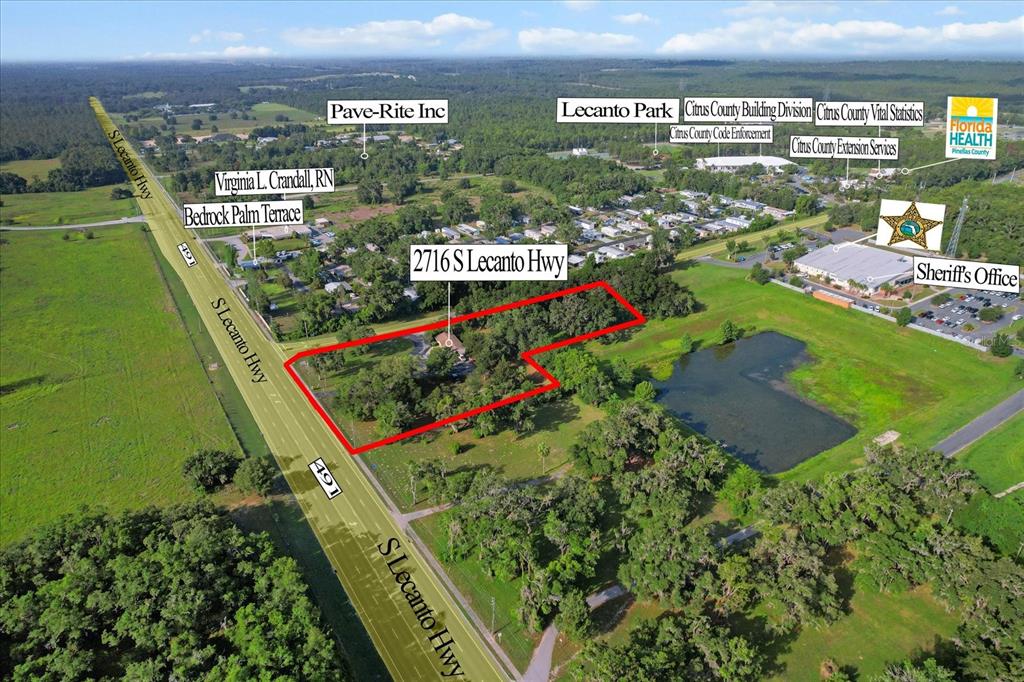 This aerial view shows a wooded property outlined in red along a highway — 2716 S LECANTO HIGHWAY, LECANTO, FL