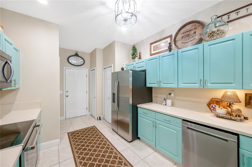 A bedroom features a wrought iron bed, a ceiling fan, and a view of a lake — 11517 CAPTIVA KAY DRIVE, RIVERVIEW, FL