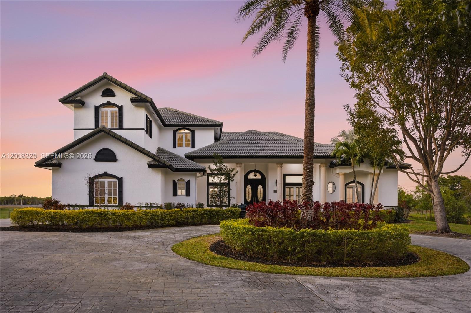 A two-story white house with a dark tile roof and a circular paved driveway — 20401 SW 48th Pl, Southwest Ranches FL 33332, SOUTHWEST RANCHES, FL