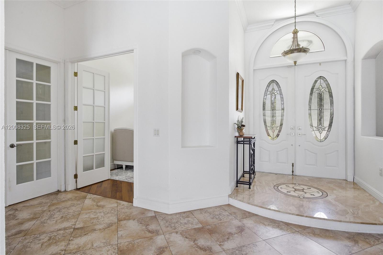 The foyer features a raised marble entryway, double glass-paneled doors, and tile flooring — 20401 SW 48th Pl, Southwest Ranches FL 33332, SOUTHWEST RANCHES, FL
