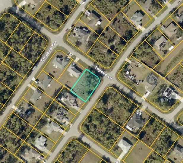 This is an aerial map showing a vacant residential lot highlighted in blue — LOT 12 TOPEKA LANE, NORTH PORT, FL