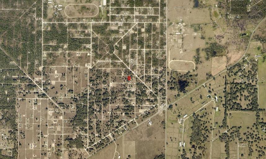 This is an aerial map view showing a red marker on a residential property lot — TBD SW 27 STREET, OCALA, FL