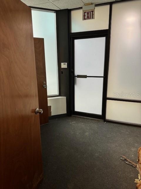 An interior office space features a wooden door, a frosted glass exit door, and carpeted flooring — 1118 S ORANGE AVENUE UNIT 104, ORLANDO, FL