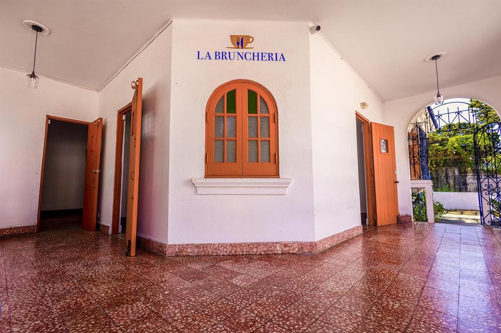 A covered outdoor patio features tiled flooring, a central window, and two open doorways — 70 Calle DEL BOSQUE, MAYAGUEZ, PR