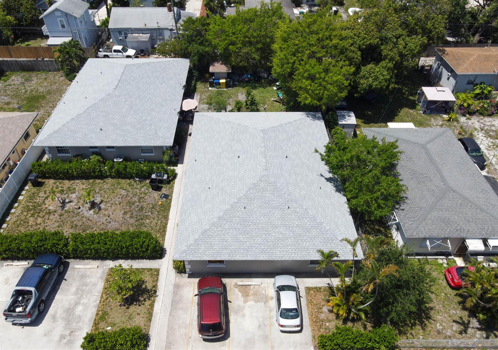An aerial view shows a gray house with a hip roof and adjacent parking spaces — 909 S N Street, FL 33460, FL