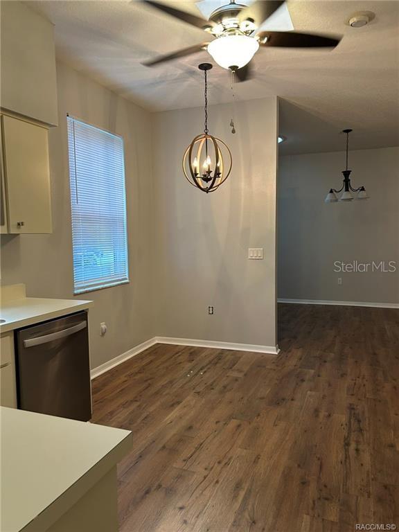 A kitchen and dining area feature wood-look flooring, a ceiling fan, and two pendant lights — 6821 E QUEENSBURY LANE, INVERNESS, FL
