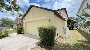 A yellow two-story house with a two-car garage and a concrete driveway — 216 VERDI STREET, DAVENPORT, FL