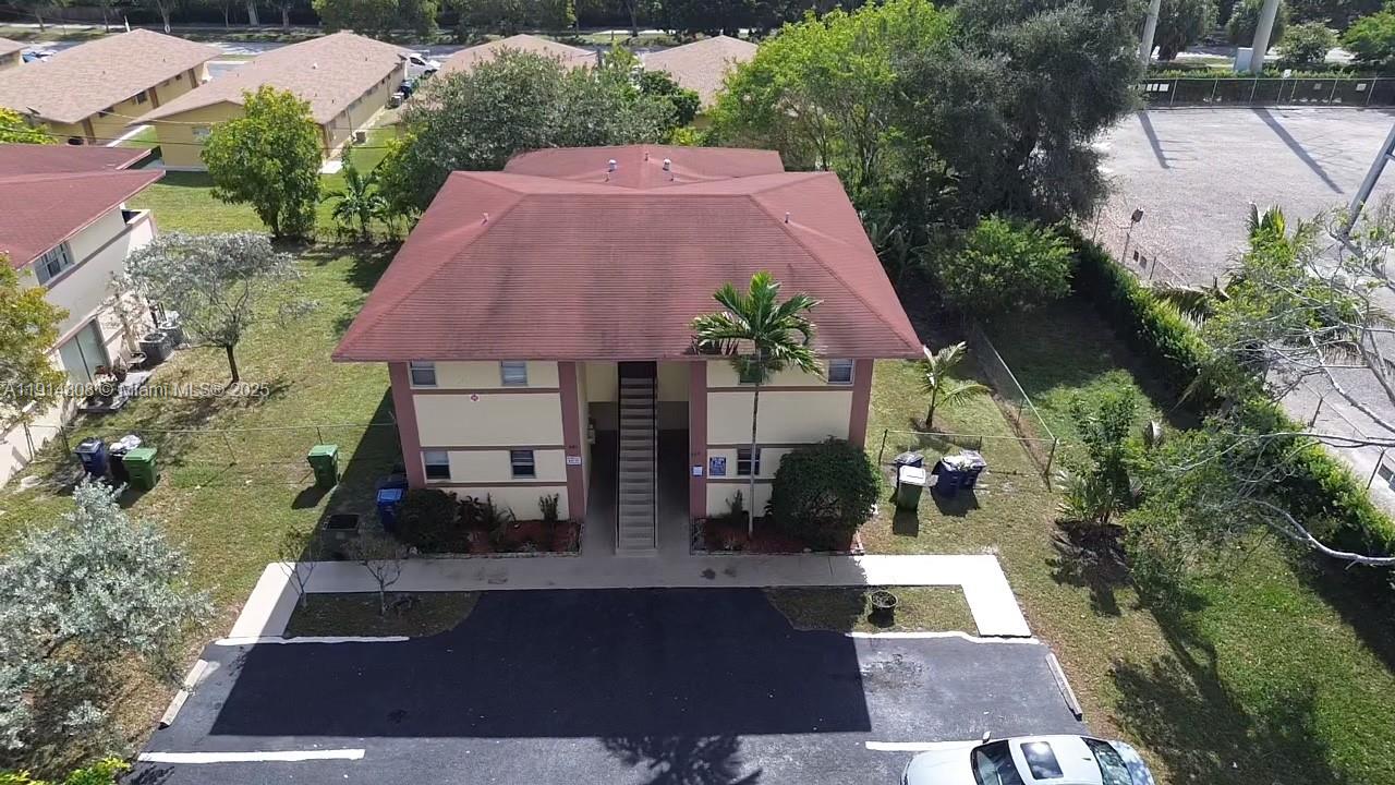 An aerial view of a two-story apartment building with a red roof and parking lot — 825 SW 10th St, Hallandale Beach FL 33009, HALLANDALE BEACH, FL