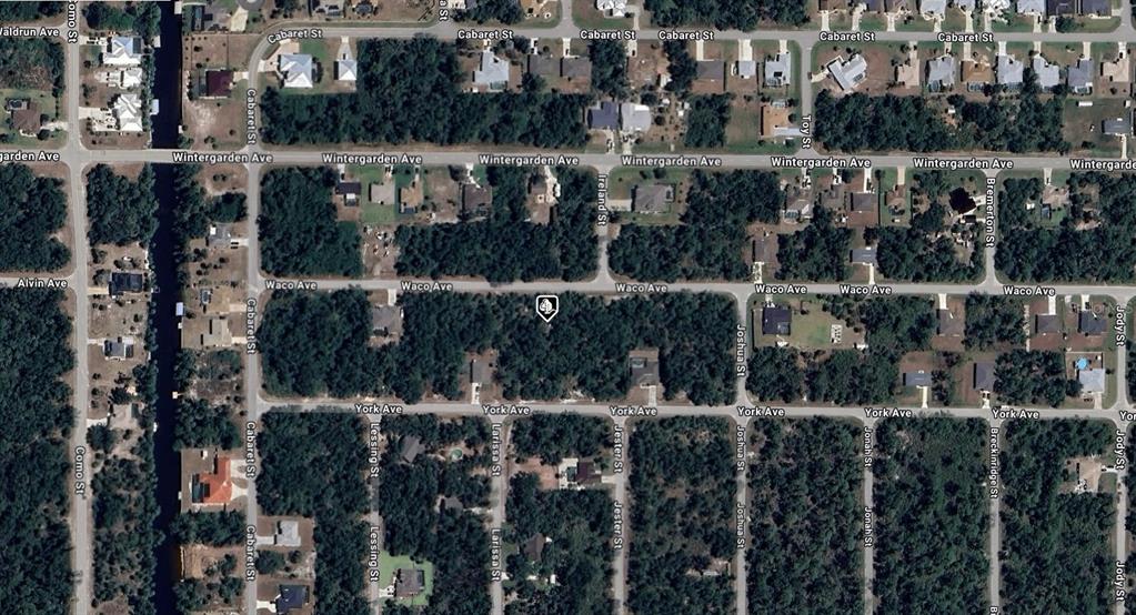 This is an aerial map view of a residential neighborhood with streets and wooded lots — 17359 WACO AVENUE, PORT CHARLOTTE, FL