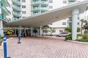 A paved driveway leads to the covered entrance of a multi-story residential building — 3801 S Ocean Dr # 8U, Hollywood FL 33019, HOLLYWOOD, FL