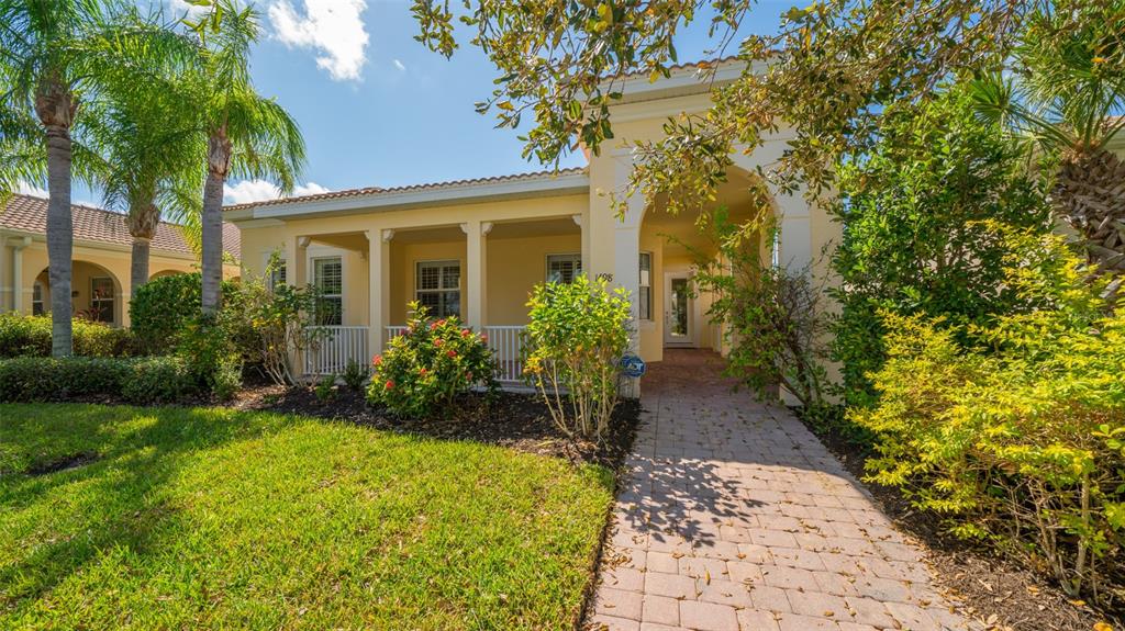 A single-story house with a covered front porch, a brick walkway, and palm trees — 1498 ERNESTO DRIVE, SARASOTA, FL