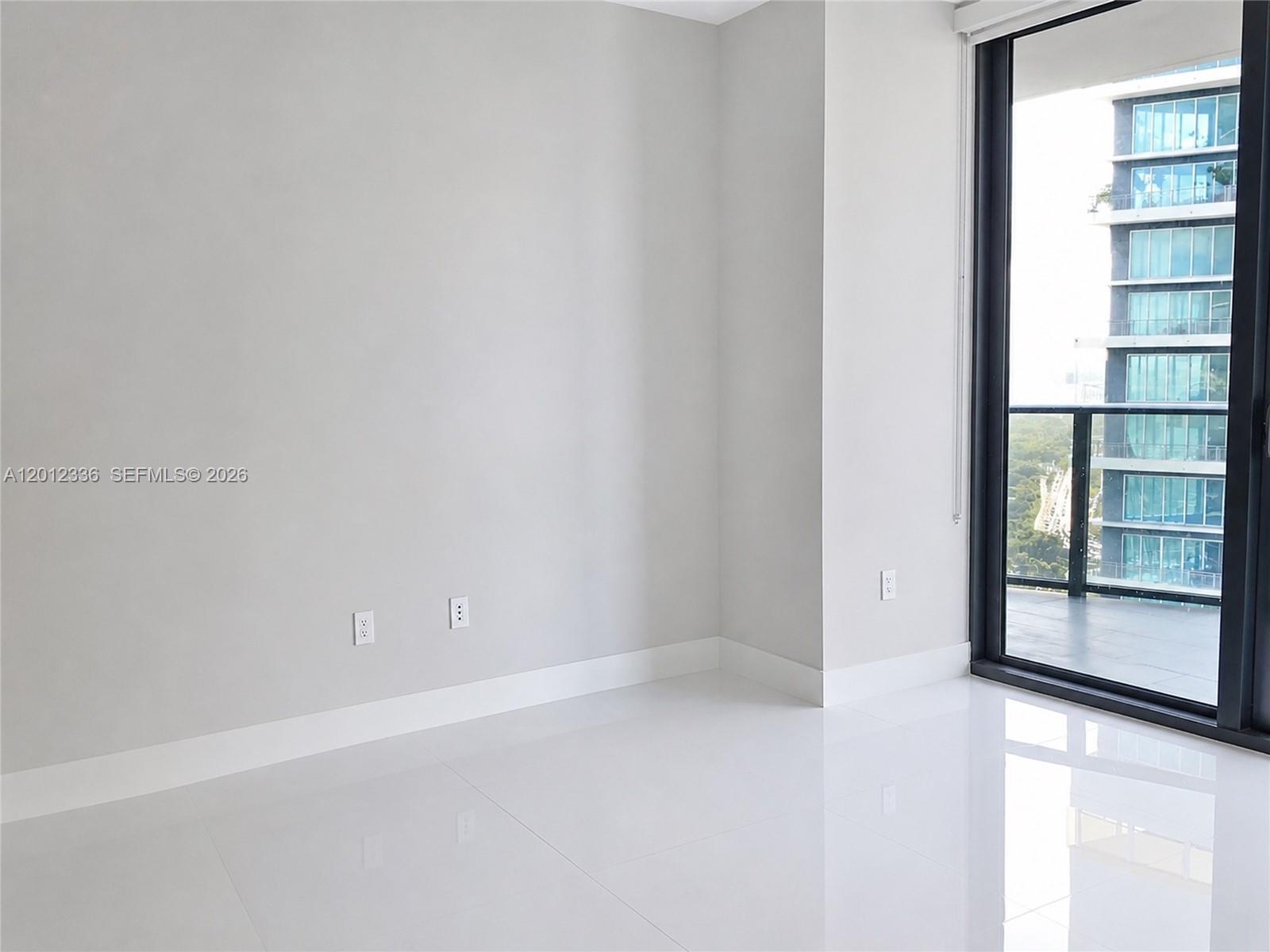 A modern kitchen features light wood cabinets, stainless steel appliances, and white tile flooring — 1300 S Miami Ave # 4507, Miami FL 33130, MIAMI, FL