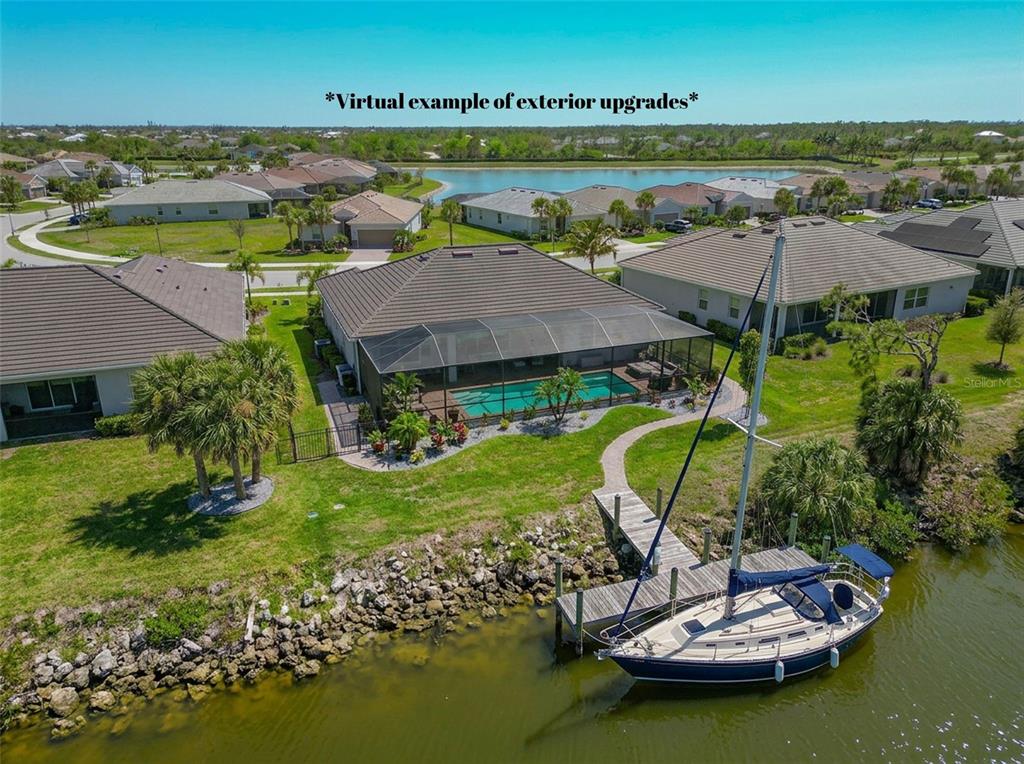 An aerial view shows a house with a screened pool and a private dock — 14500 PONCE DE LEON TRAIL, PORT CHARLOTTE, FL