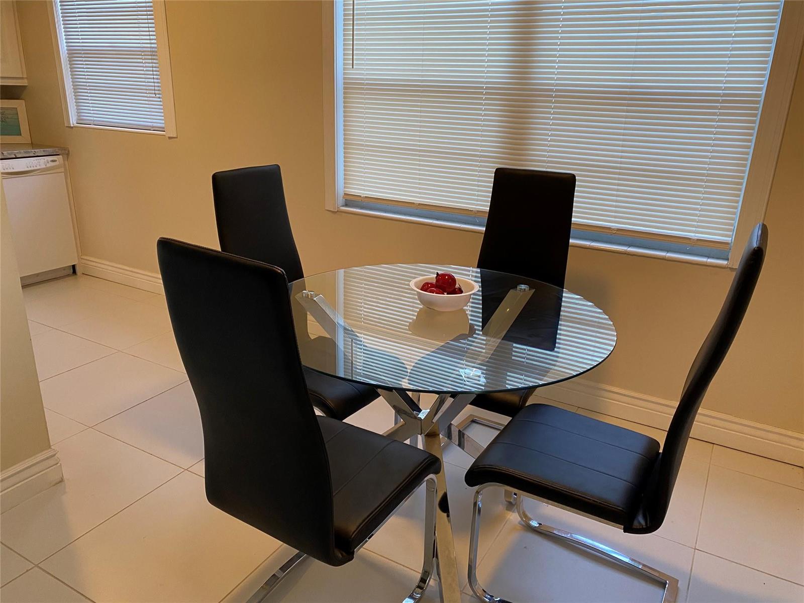 A living room features a beige sectional sofa, a floor vase, and a large window — 209 Ventnor M # 209, Deerfield Beach FL 33442, DEERFIELD BEACH, FL