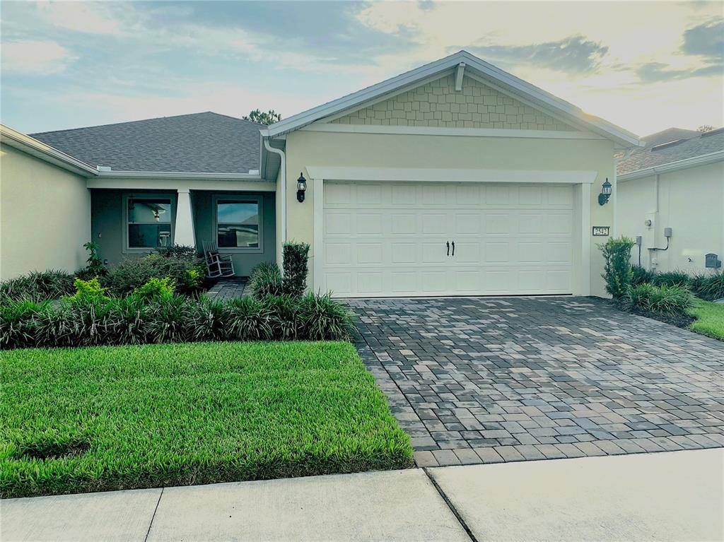 A duplex home features two garage doors, a shared entrance, and a front yard fire hydrant — 2542 CLIFF WAY, ST CLOUD, FL