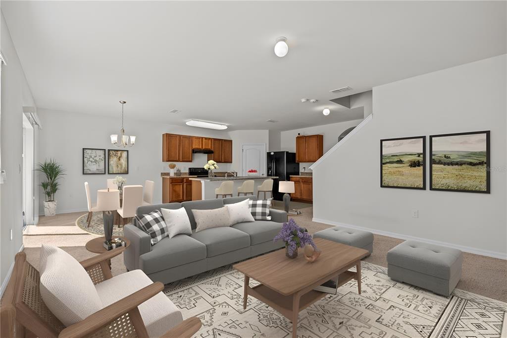 A living room with a grey sofa, coffee table, and open kitchen with wooden cabinets — 817 SHEEN CIRCLE, HAINES CITY, FL