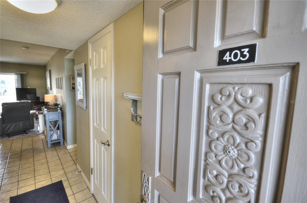 A kitchen features white cabinets, a white refrigerator, a dishwasher, and a double-basin sink — 4155 S ATLANTIC AVENUE UNIT 403, NEW SMYRNA BEACH, FL