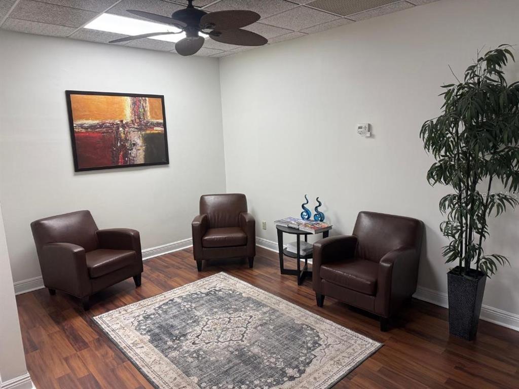 A waiting room features three brown leather chairs, a rug, and a potted plant — 845 N GARLAND AVENUE UNIT 220, ORLANDO, FL