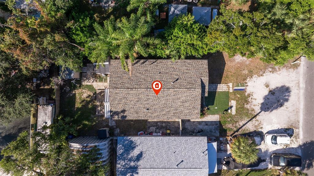 An aerial view shows a house with a shingled roof and surrounding yard and trees — 5322 25TH AVENUE S, GULFPORT, FL