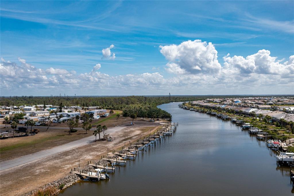 An aerial view of a canal lined with boat docks and residential properties — 7412 HESTON STREET, PORT CHARLOTTE, FL
