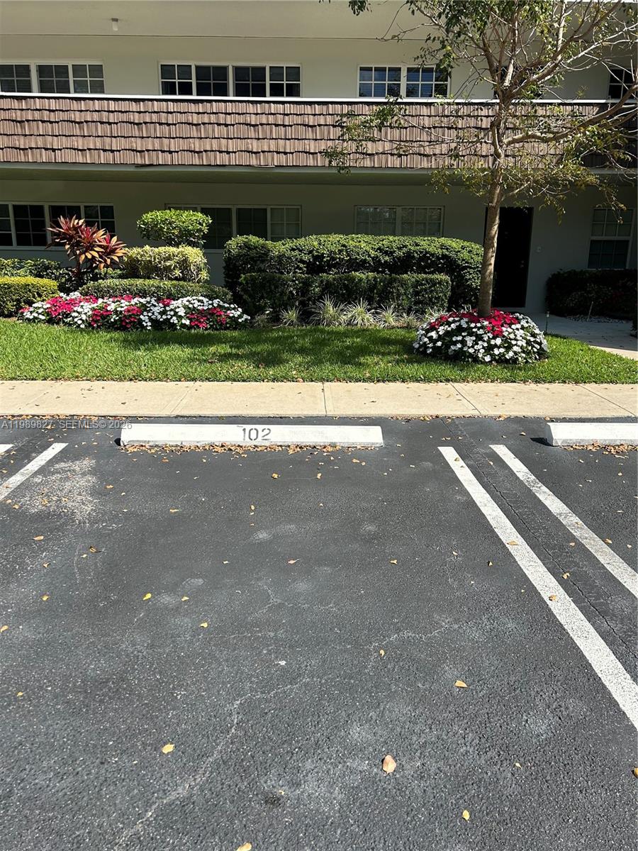 The exterior view shows a multi-story apartment building with a parking space numbered 102 — 4017 N Cypress Dr # 102, Pompano Beach FL 33069, POMPANO BEACH, FL