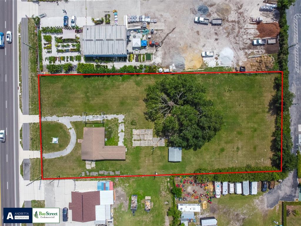 An aerial view shows a rectangular lot with a house, a large tree, and outbuildings — 34020 & 34024 STATE ROAD 54, WESLEY CHAPEL, FL