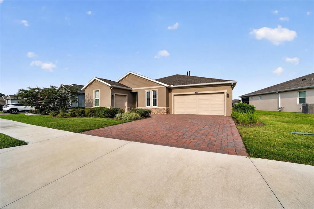 A single-story house with a brick paver driveway and a two-car garage — 4436 NW 53RD COURT, OCALA, FL
