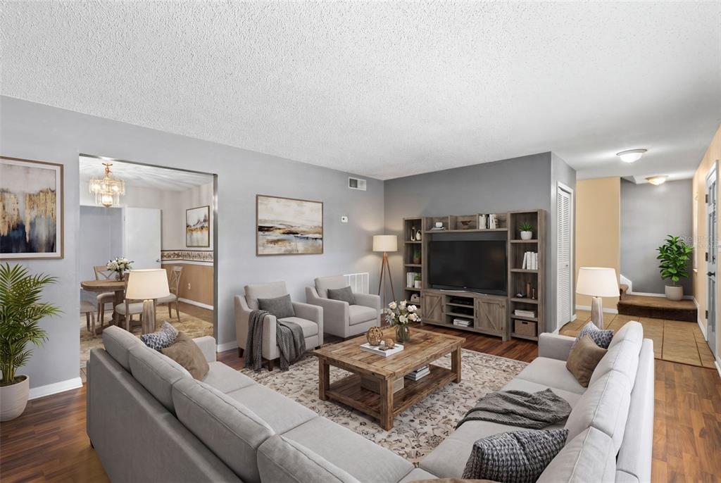A living room features a grey sectional sofa, two armchairs, and a wooden entertainment center — 8698 HILLSIDE DRIVE, ORLANDO, FL