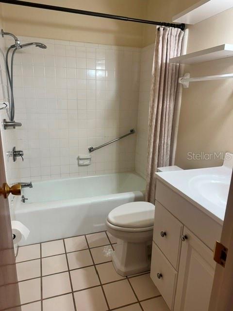 A bathroom features a white tiled bathtub shower combination, a toilet, and a vanity cabinet — 37623 CAMPHOR DRIVE, DADE CITY, FL