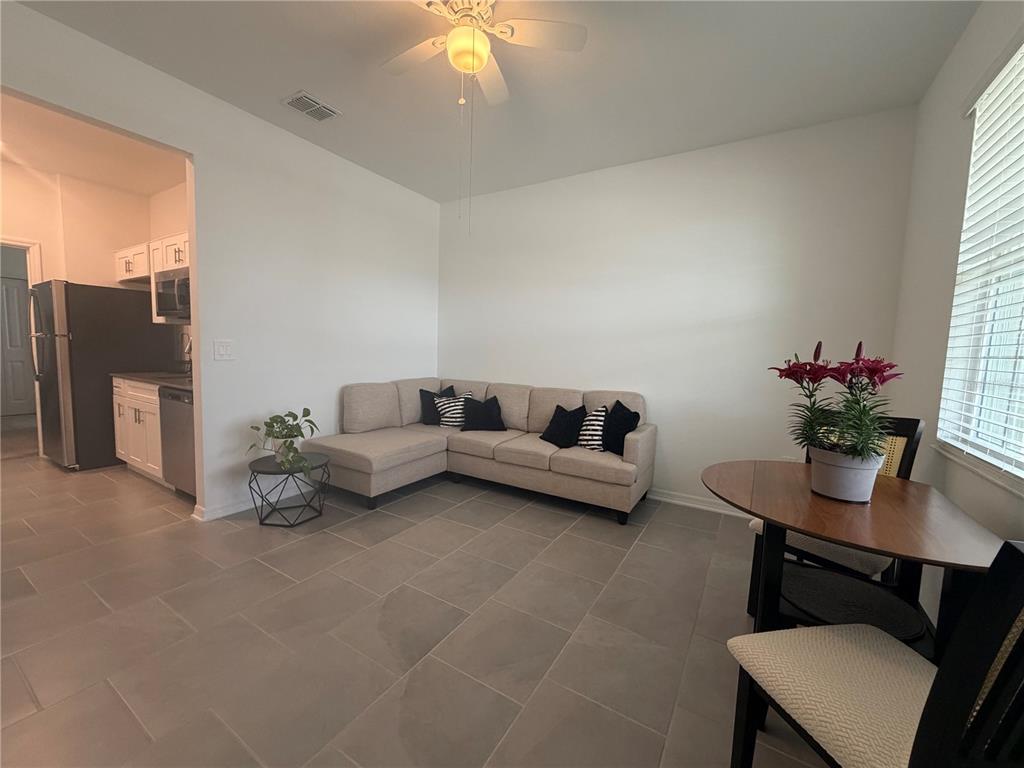 A living and dining area features tile flooring, a sectional sofa, and a ceiling fan — 652 GROVE STREET, WINTER HAVEN, FL