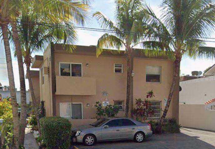 A two-story tan apartment building with palm trees and a parked car in front — 460 SW 7th Street, Miami FL 33130, MIAMI, FL