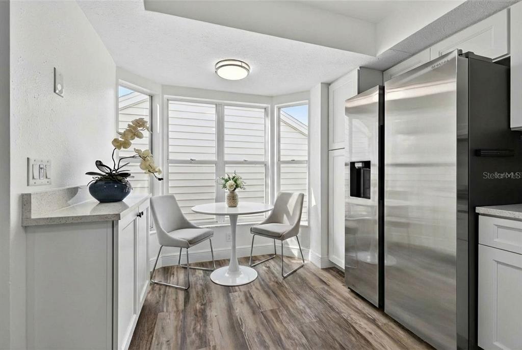 A wooden deck features a wicker lounge chair, potted plants, and a small picket fence — 5300 BAYSHORE BOULEVARD UNIT C6, TAMPA, FL