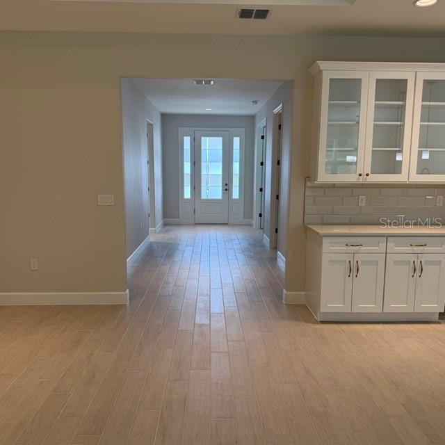 A view from a kitchen looking toward a front entryway with light-colored tile flooring — 380 E DUSTY COURT, HERNANDO, FL