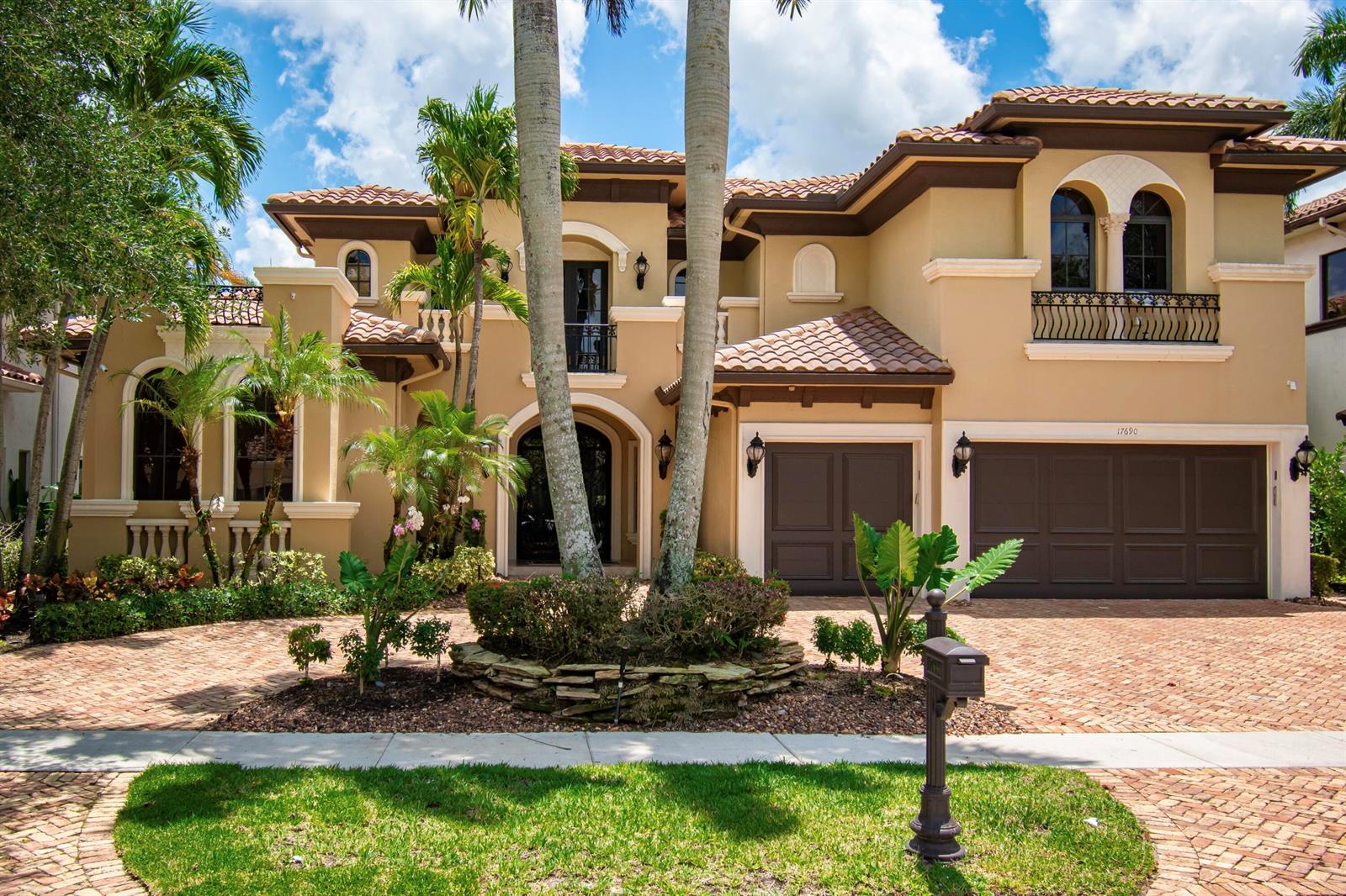 A two-story Mediterranean-style house with a brick driveway, tile roof, and palm trees — 17690 Middlebrook Way, Boca Raton FL 33496, BOCA RATON, FL