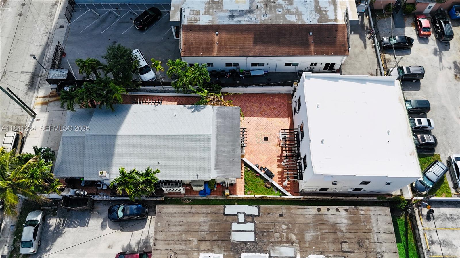 An aerial view shows two adjacent buildings with a tiled courtyard and surrounding parking lots — 1238 SW 4th St, Miami FL 33135, MIAMI, FL