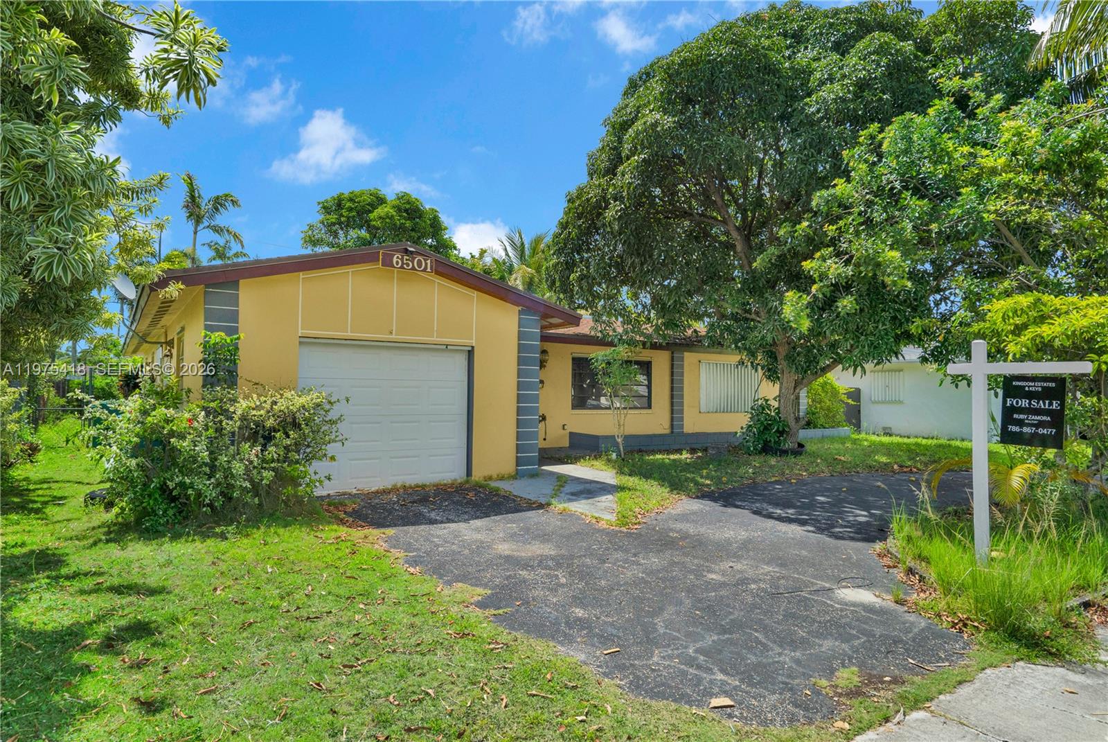 A yellow single-story house with a garage and a for-sale sign in the front yard — 16501 SW 102nd Ct, Miami FL 33157, MIAMI, FL